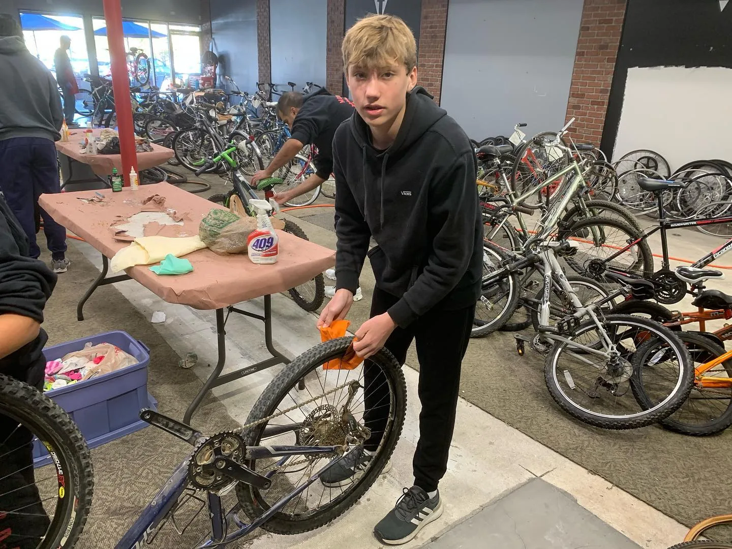 A volunteer working on a bicycle at the December 2022 adopt-a-family repair event