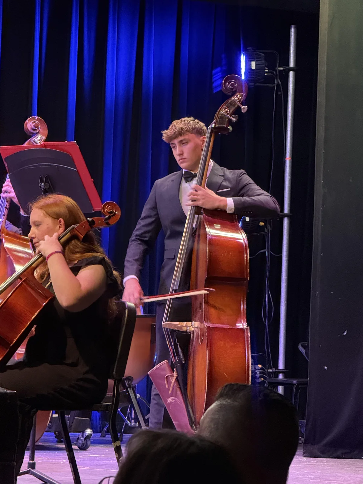 Sammy Fox playing upright bass onstage in his orchestra